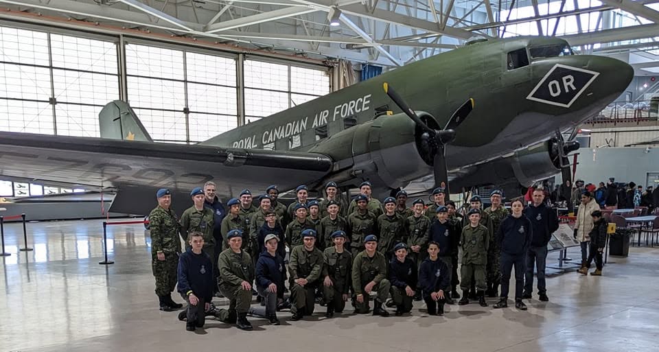 23 Squadron cadets and staff gathered in front of a Royal Canadian Air Force aircraft