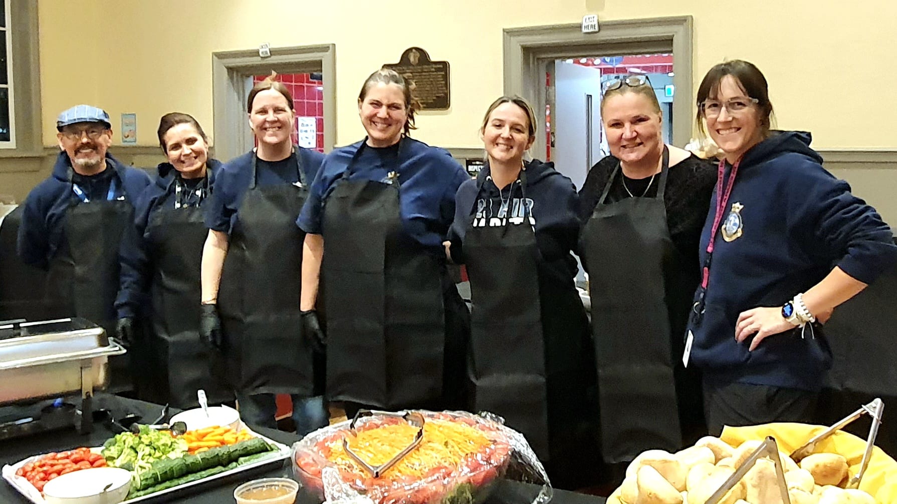 Squadron volunteers serving food at a squadron community event