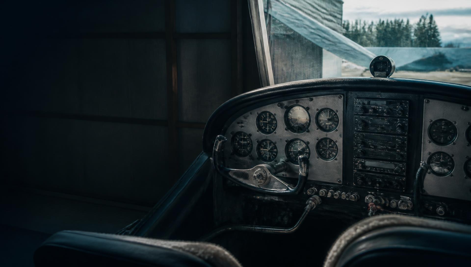 Close-up view of an aircraft cockpit with analog flight instruments and controls